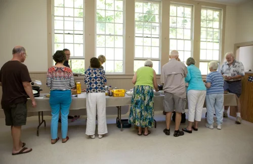 Residents getting food at the Balsam Community Center Potluck dinner